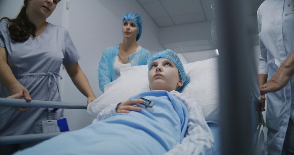 young girl being wheeled to surgery