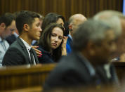 Sister of Oscar Pistorius, Aimee Pistorius, center, is comforted as she listens to forensic evidence during his trial in court in Pretoria, South Africa, Thursday March 13, 2014. Pistorius is charged with the shooting death of his girlfriend Reeva Steenkamp, on Valentines Day in 2013. (AP Photo/Alet Pretorius, Pool)
