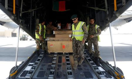 Afghan National Army (ANA) soldiers load military equipment onto a C-130 military transport plane before a flight in Kabul, Afghanistan July 9, 2017. Picture taken on July 9, 2017. REUTERS/Omar Sobhani