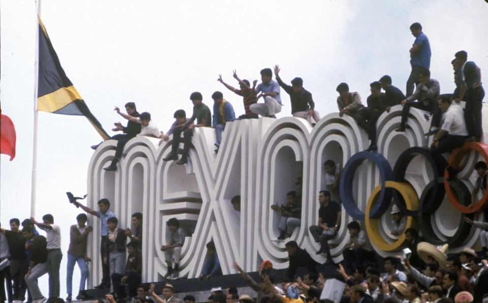 <p>Crowds climb on top of Mexico's Olympic sign during the opening ceremony of the 1968 Summer Olympics in Mexico City. This marks the first time the Olympics were broadcasted in color. </p>