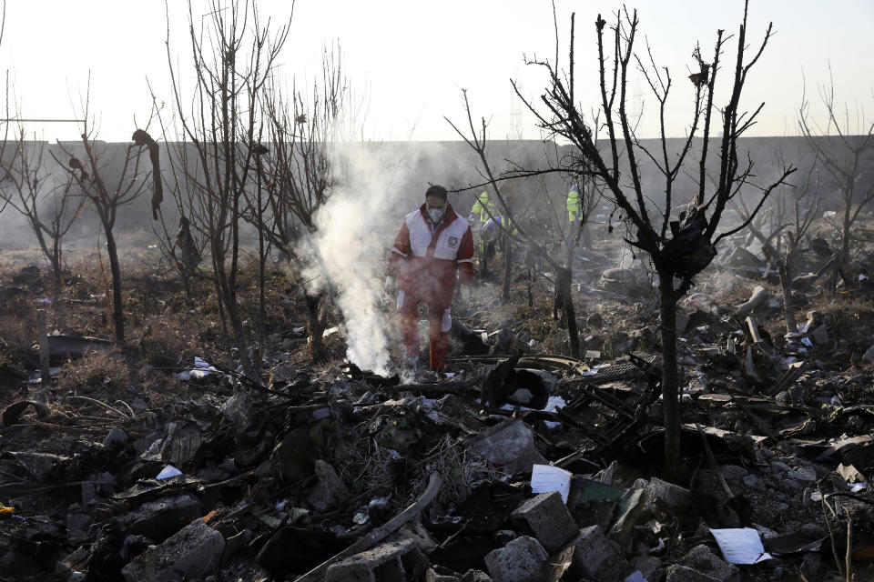 Rescue workers search the scene where an Ukrainian plane crashed in Shahedshahr, southwest of the capital Tehran, Iran, Wednesday, Jan. 8, 2020. A Ukrainian airplane carrying 176 people crashed on Wednesday shortly after takeoff from Tehran's main airport, killing all onboard. (AP Photo/Ebrahim Noroozi)