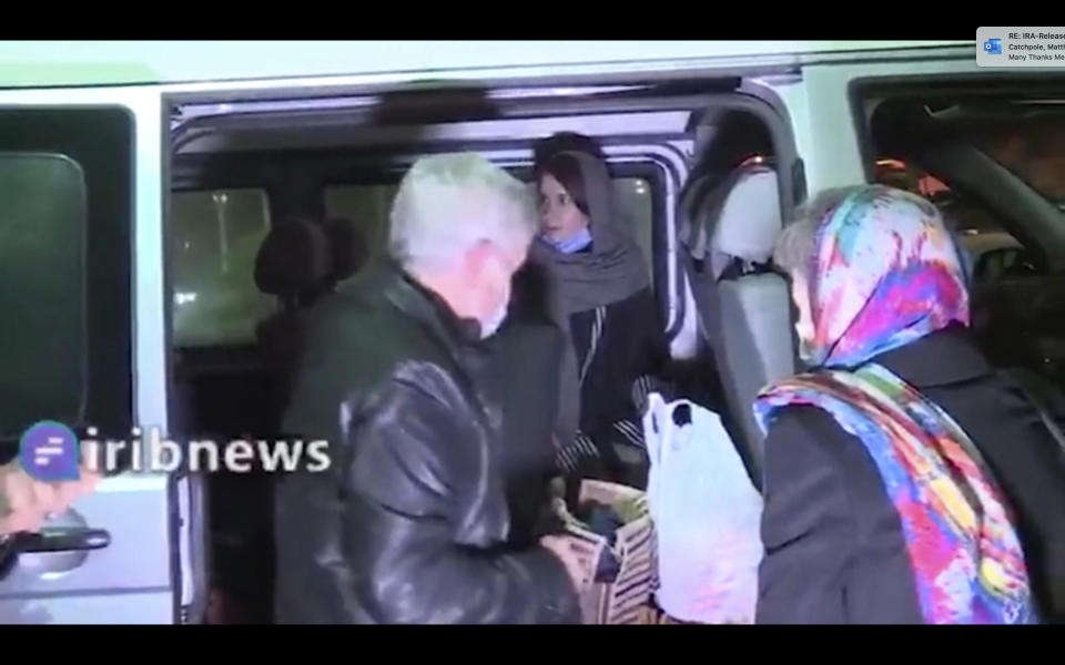 In this frame grab from Iranian state television video aired Wednesday, Nov. 25, 2020, British-Australian academic Kylie Moore-Gilbert, center inside van, is seen in Tehran, Iran. Iran has freed Moore-Gilbert, who has been detained in Iran for more than two years, in exchange for three Iranians held abroad, state TV reported Wednesday. (Iranian State Television via AP)