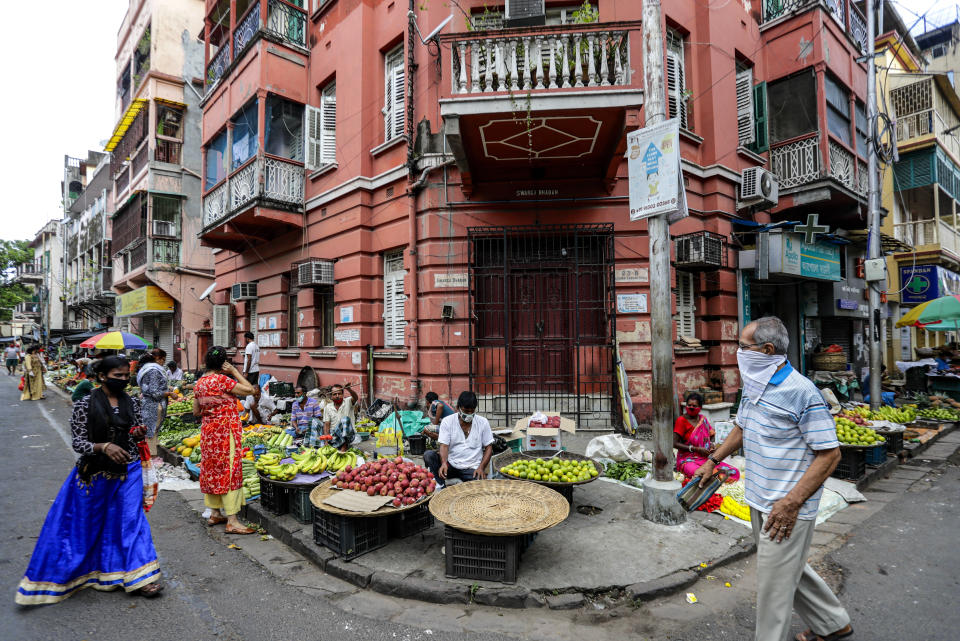 People wearing face masks to prevent the spread of the coronavirus shop for vegetables in Kolkata, India, Tuesday, Sept. 15, 2020. India's coronavirus cases are now the second-highest in the world and only behind the United States. (AP Photo/Bikas Das)