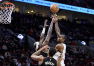 Los Angeles Clippers forward Kawhi Leonard, right, shoots over Portland Trail Blazers center Duop Reath, left, and forward Kris Murray during the first half of an NBA basketball game in Portland, Ore., Wednesday, March 20, 2024. (AP Photo/Craig Mitchelldyer)