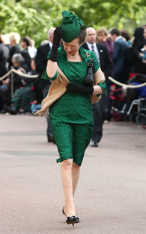 Princess Anne sensibly holds on to her hat - Credit: Gareth Fuller/PA Wire