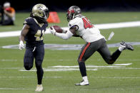 Tampa Bay Buccaneers inside linebacker Devin White, right, intercepts a pass in front of New Orleans Saints running back Alvin Kamara (41) during the second half of an NFL divisional round playoff football game, Sunday, Jan. 17, 2021, in New Orleans. (AP Photo/Brett Duke)