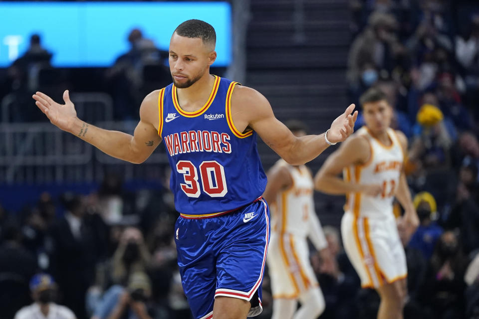 Golden State Warriors guard Stephen Curry (30) reacts after shooting a 3-point basket against the Atlanta Hawks during the first half of an NBA basketball game in San Francisco, Monday, Nov. 8, 2021. (AP Photo/Jeff Chiu)