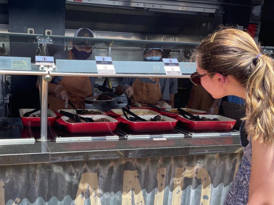 A passenger looks at her options at Guy’s Pig & Anchor Bar-B-Que Smokehouse.