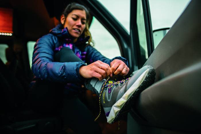 Woman tying Columbia facet hiking shoe