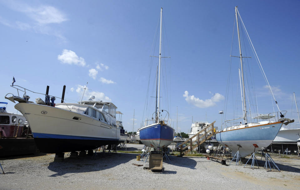 In this Tuesday, July 9, 2019 photo, boats that sometimes ply the Tennessee-Tombigbee Waterway are parked in dry storage at Demopolis Yacht Basin in Demopolis, Ala. While commercial traffic has been lower than expected on the waterway, it is popular for retirees and others who travel inland streams and intracoastal waters on a journey called the "Great Loop." (AP Photo/Jay Reeves)