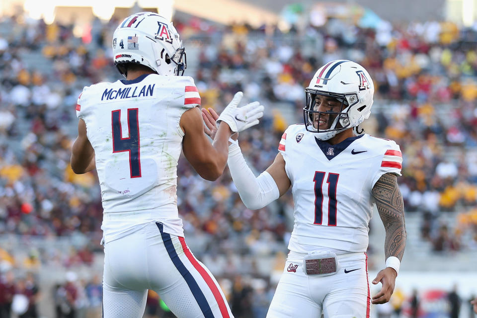 TEMPE, ARIZONA - NOVEMBER 25: Wide receiver Tetairoa McMillan #4 of the Arizona Wildcats celebrates with Noah Fifita #11 after catching a 50-yard touchdown reception against the Arizona State Sun Devils during the second half of the NCAAF game at Mountain America Stadium on November 25, 2023 in Tempe, Arizona. (Photo by Christian Petersen/Getty Images)