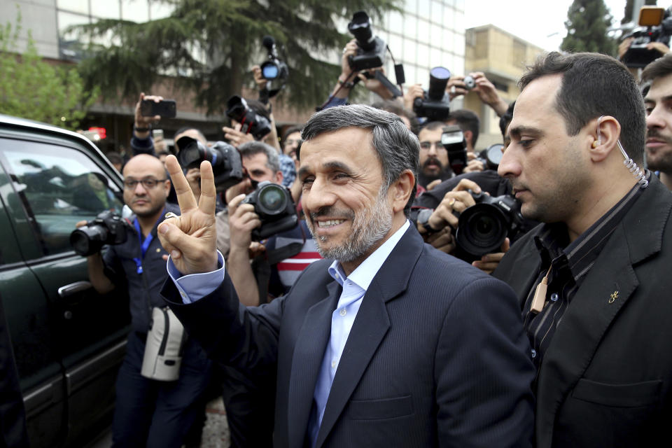 Former Iranian President Mahmoud Ahmadinejad flashes the victory sign as he arrives at the Interior Ministry to register his candidacy for the upcoming presidential elections, in Tehran, Iran, Wednesday, April 12, 2017. Ahmadinejad on Wednesday unexpectedly filed to run in the country's May presidential election, contradicting a recommendation from the supreme leader to stay out of the race. (AP Photo/Ebrahim Noroozi)
