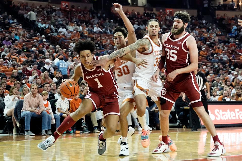 Jan 11, 2022; Austin, Texas, USA; Oklahoma Sooners forward Jalen Hill (1) drives to the basket while defended by  Texas Longhorns forwards Christian Bishop (32) and Brock Cunningham (30) during the second half at Frank C. Erwin Jr. Center. Mandatory Credit: Scott Wachter-USA TODAY Sports