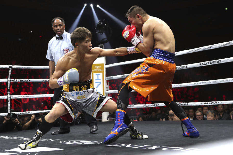 Japan's Naoya Inoue, left, sends a left to Philippines' Nonito Donaire in the first round of their World Boxing Super Series bantamweight final match in Saitama, Japan, Thursday, Nov. 7, 2019. Inoue beat Donaire with a unanimous decision to win the championship. (AP Photo/Toru Takahashi)