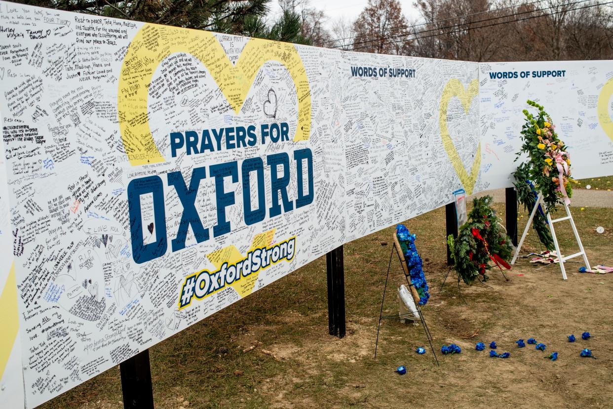 Handwritten messages are left at the memorial site outside Oxford High School in Oxford, Michigan.