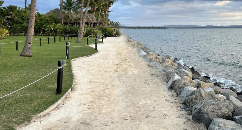 A photo of garden lights and a footpath running by the ocean at the Club Wyndham resort in Fiji in June 2022.