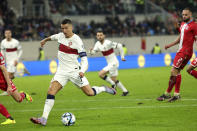 Portugal's Cristiano Ronaldo, center, scores his sides fourth goal during the Euro 2024 group J qualifying soccer match between Luxembourg and Portugal at the Stade de Luxembourg in Luxembourg, Sunday, March 26, 2023. (AP Photo/Olivier Matthys)