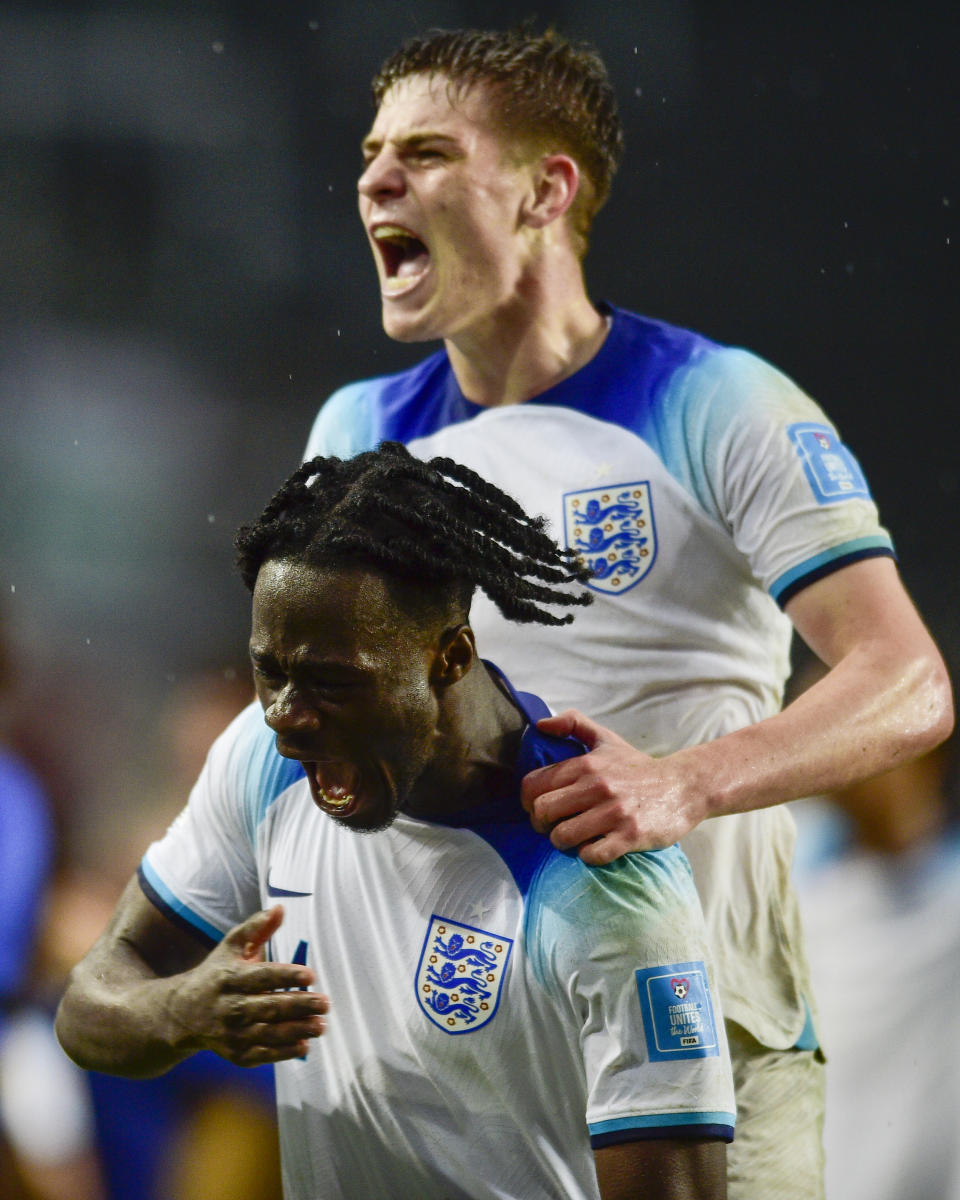 England's Darko Gyabi, bottom, celebrates scoring his side's 3rd goal against Uruguay during a FIFA U-20 World Cup Group E soccer match at Diego Maradona stadium in La Plata, Argentina, Thursday, May 25, 2023. (AP Photo/Gustavo Garello)