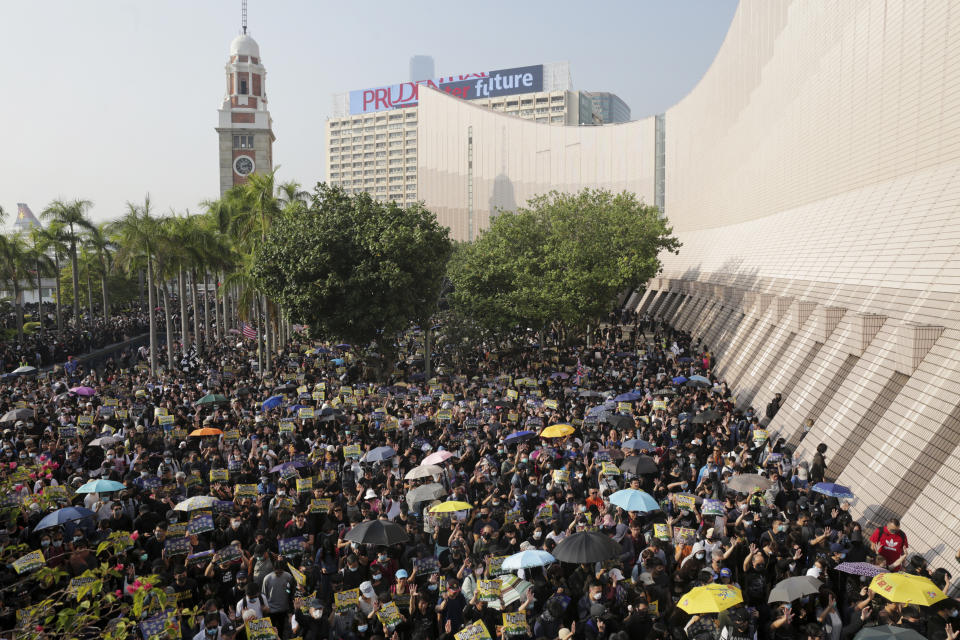 Pro-democracy protesters gather in a rally in Hong Kong, Sunday, Dec. 1, 2019. A huge crowd took to the streets of Hong Kong on Sunday, some driven back by tear gas, to demand more democracy and an investigation into the use of force to crack down on the six-month-long anti-government demonstrations. (Max Au/HK01 via AP)