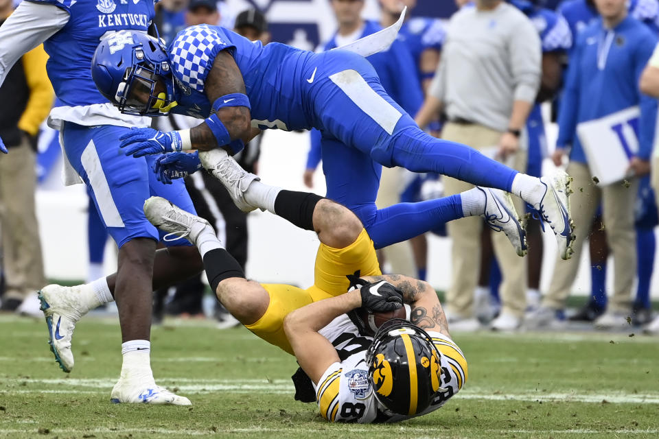 Iowa wide receiver Nico Ragaini (89) pulls in a pass as Kentucky defensive back Tyrell Ajian (6) defends in the second half of the Music City Bowl NCAA college football game Saturday, Dec. 31, 2022, in Nashville, Tenn. Iowa won 21-0. (AP Photo/Mark Zaleski)