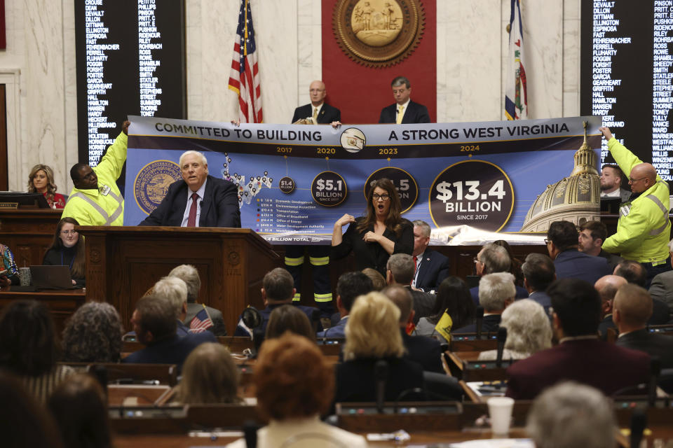 West Virginia Gov. Jim Justice, left, talks about the outcome of his Roads to Prosperity program during the State of the State address in Charleston, W.Va., on Wednesday, Jan. 10, 2024. (AP Photo/Chris Jackson)