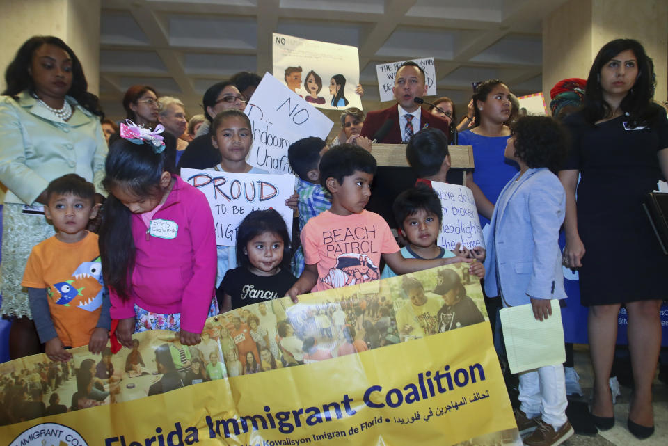 CORRECTS THE NAME THE BILLS ARE DESCRIBED AS TO RULE OF LAW ADHERENCE ACT INSTEAD OF FAMILY SEPARATION BILLS - Top right, Rep. Carlos Guillermo Smith (D-Orlando) speaks out against the Law Adherence Act HB 527 and SB 168 Tuesday, April 23, 2019, during a press conference in the Florida Capitol in Tallahassee, Fla. (AP Photo/Phil Sears)