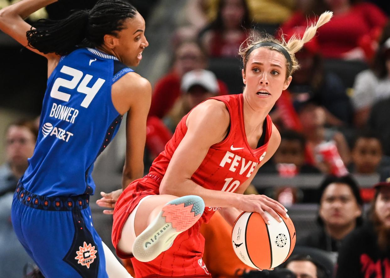 Indiana Fever guard Lexie Hull (10) steals the ball against Connecticut Sun forward DeWanna Bonner (24) during the season opener against Connecticut Sun on Friday, May 19, 2023 at Gainbridge Fieldhouse in Indianapolis. 