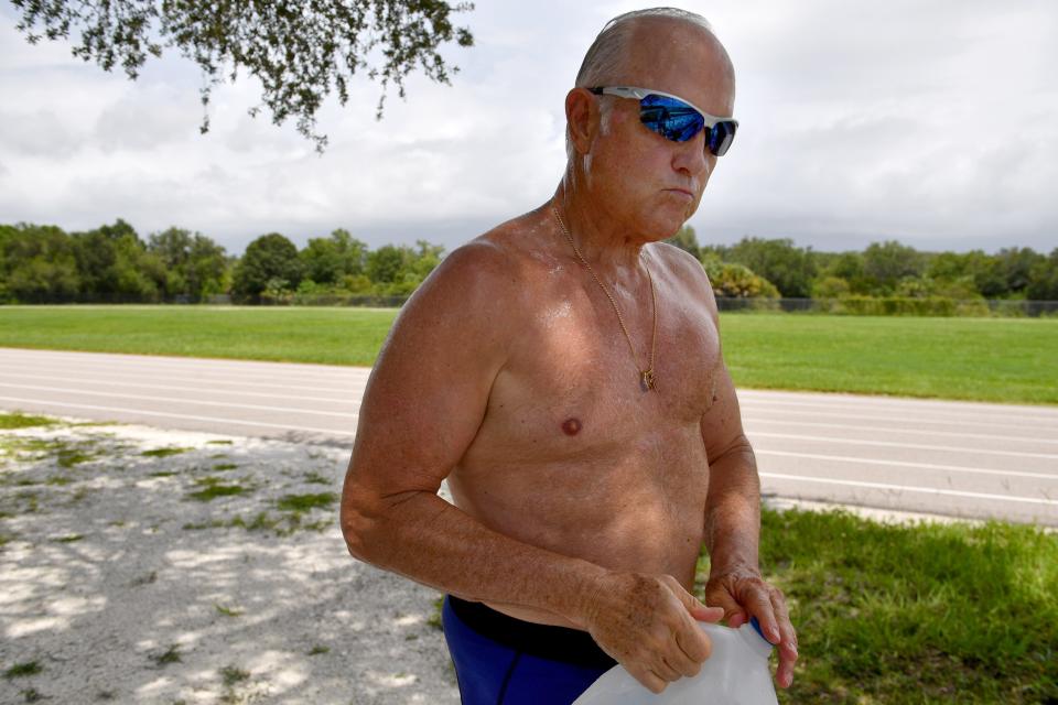 Mike Lynch takes a break from his workout to drink water recently at the track at Pine View School in Osprey, Florida.