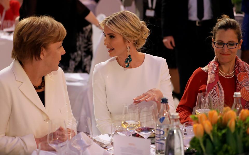 Ivanka Trump, daughter and adviser of U.S. President Donald Trump, center, and German Chancellor Angela Merkel, left, attend a dinner after they participated in the W20 Summit in Berlin - Credit: AP