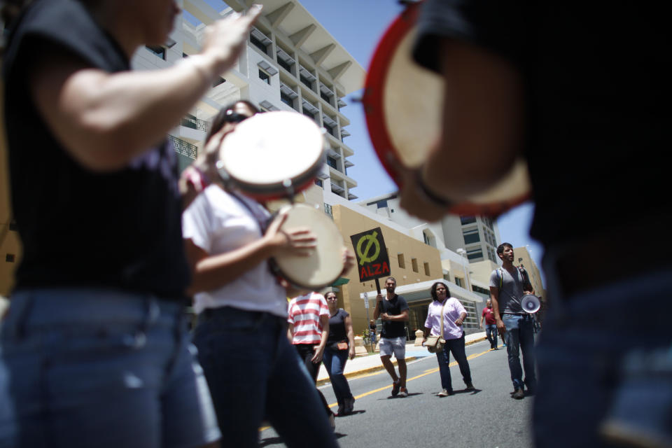 Students demonstrate during a 24-hour protest against a tuition increase outside the University of Puerto Rico in San Juan, Puerto Rico, Wednesday, April 23, 2014. The protest was called even though officials at the university have extended a one year moratorium on the four percent increase. (AP Photo/Ricardo Arduengo)