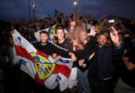 Leeds United fans celebrate outside Elland Road after Huddersfield Town beat West Bromwich Albion to seal their promotion to the Premier League.