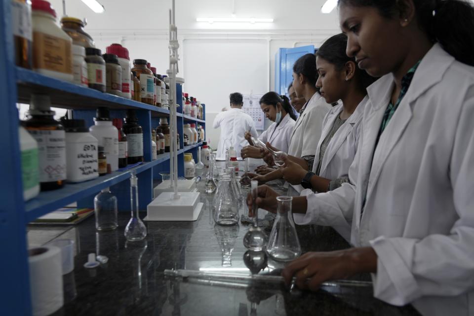 Lab workers conduct tests at the Chemical Oceanography lab at Cochin University of Science and Technology in Eloor, Kerala state, India, Friday, March 3, 2023. Trainees with the Pollution Control Board do daily trips to collect samples from six different points along the Periyar River. (AP Photo)