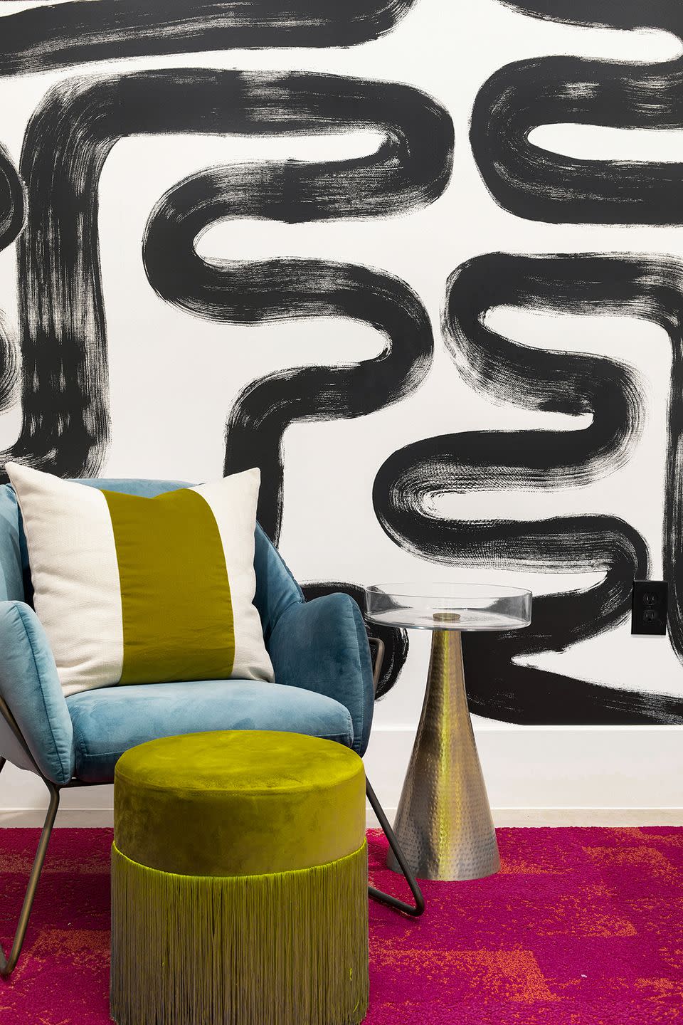 abstract mural and blue armchair