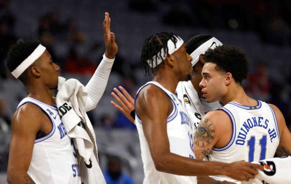 FORT WORTH, TX - MARCH 11: Lester Quinones #11 of the Memphis Tigers celebrates with teammates after scoring a basket against the UCF Knights in the first half of the American Athletic Conference Mens Basketball Tournament Quarterfinals at Dickies Arena on March 11, 2022 in Fort Worth, Texas. (Photo by Ron Jenkins/Getty Images)