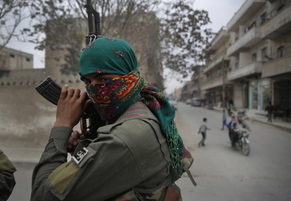 FILE - In this file photo dated Wednesday, March 28, 2018, a member of the Kurdish internal security forces holds his weapon during a patrol in Manbij, north Syria. U.S. President Donald Trump's decision Wednesday Dec. 19, 2018, to withdraw U.S. troops from Syria has rattled Washington's Kurdish allies, who are its most reliable partner in Syria and among the most effective ground forces battling the Islamic State group. (AP Photo/Hussein Malla, FILE)