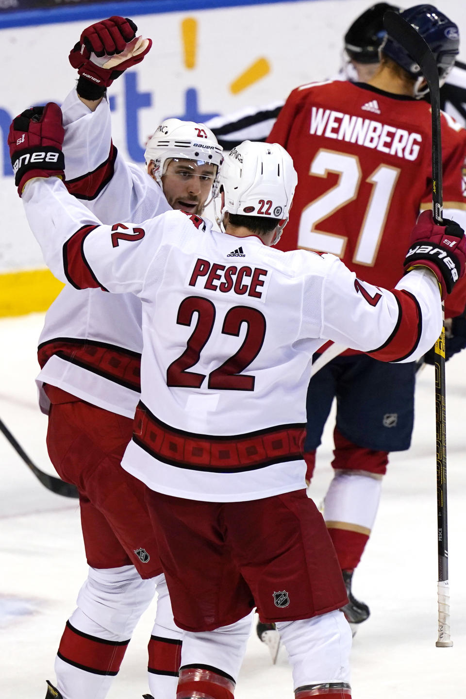 Carolina Hurricanes right wing Nino Niederreiter and defenseman Brett Pesce (22) celebrate after Niederreiter scored a goal during the second period of the team's NHL hockey game against the Florida Panthers, Thursday, April 22, 2021, in Sunrise, Fla. (AP Photo/Marta Lavandier)