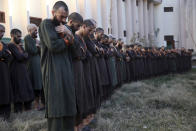 FILE- in this Dec. 21, 2019, photo, Islamic State militants either arrested or surrounded to the Afghan government are presented to media in Kabul, Afghanistan, A United Nations report says Afghanistan passed a grim milestone with more than 100,000 civilians killed or hurt in the last 10 years since the international body began documenting casualties in a war that has raged for 18 years. (AP Photo/Rahmat Gul, file)