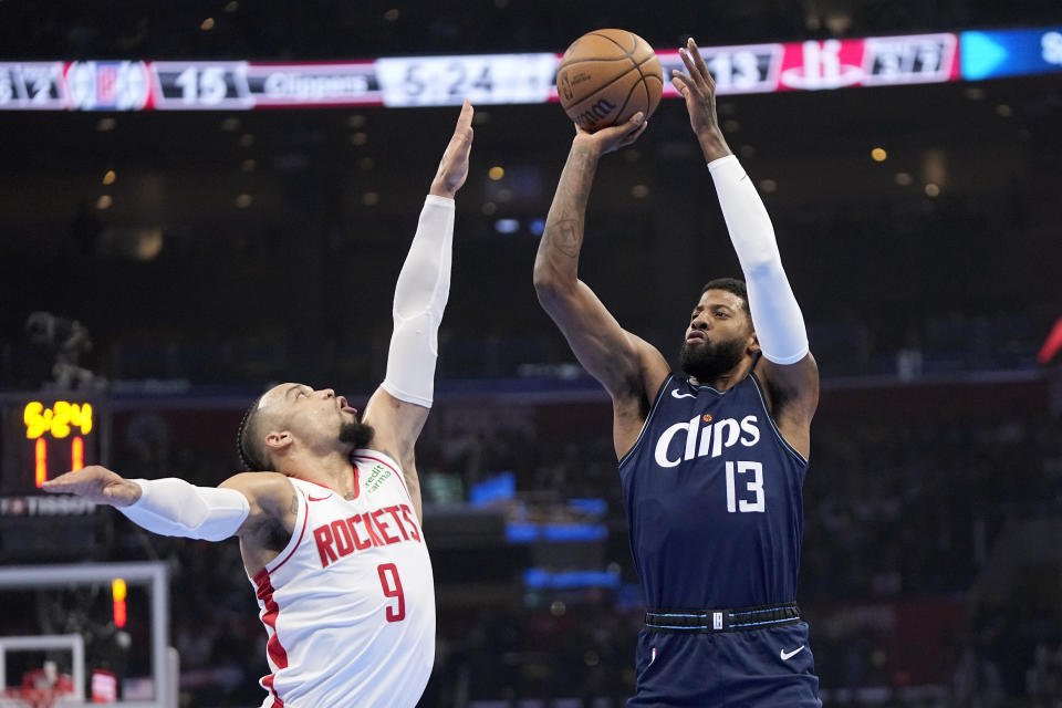 Los Angeles Clippers forward Paul George, right, shoots as Houston Rockets forward Dillon Brooks defends during the first half of an NBA basketball In-Season Tournament game Friday, Nov. 17, 2023, in Los Angeles. (AP Photo/Mark J. Terrill)