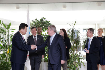 International Olympic Committee (IOC) President Thomas Bach from Germany welcomes North Korea's Olympic Committee President and Minister of Physical Culture and Sports Kim Il Guk and South Korean Sports Minister Do Jong-hwan, during a working meeting to discuss further sports cooperation between the Republic of Korea (ROK) and the Democratic People’s Republic of Korea (DPRK) as well as their bid to co-host the 2032 Summer Olympics, at the IOC Headquarters in Lausanne, Switzerland, February 15, 2019. Salvatore Di Nolfi/Pool via REUTERS