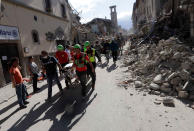 <p>The body of a victim is pulled out of the rubble following an earthquake in Amatrice Italy, Wednesday, Aug. 24, 2016. (AP Photo/Alessandra Tarantino) </p>