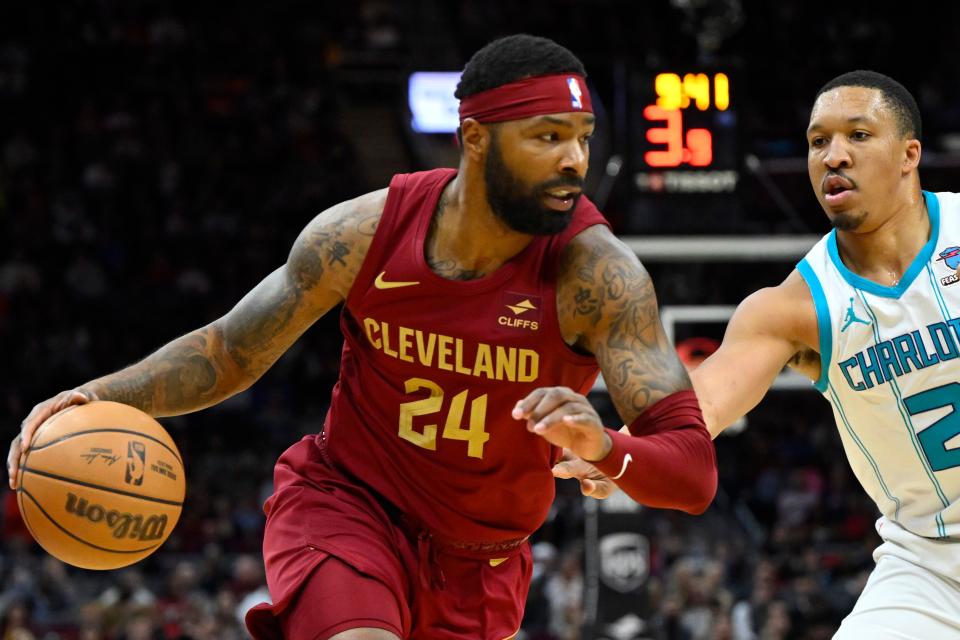 Mar 25, 2024; Cleveland, Ohio, USA; Cleveland Cavaliers forward Marcus Morris Sr. (24) dribbles beside Charlotte Hornets forward Grant Williams (2) in the second quarter at Rocket Mortgage FieldHouse. Mandatory Credit: David Richard-USA TODAY Sports