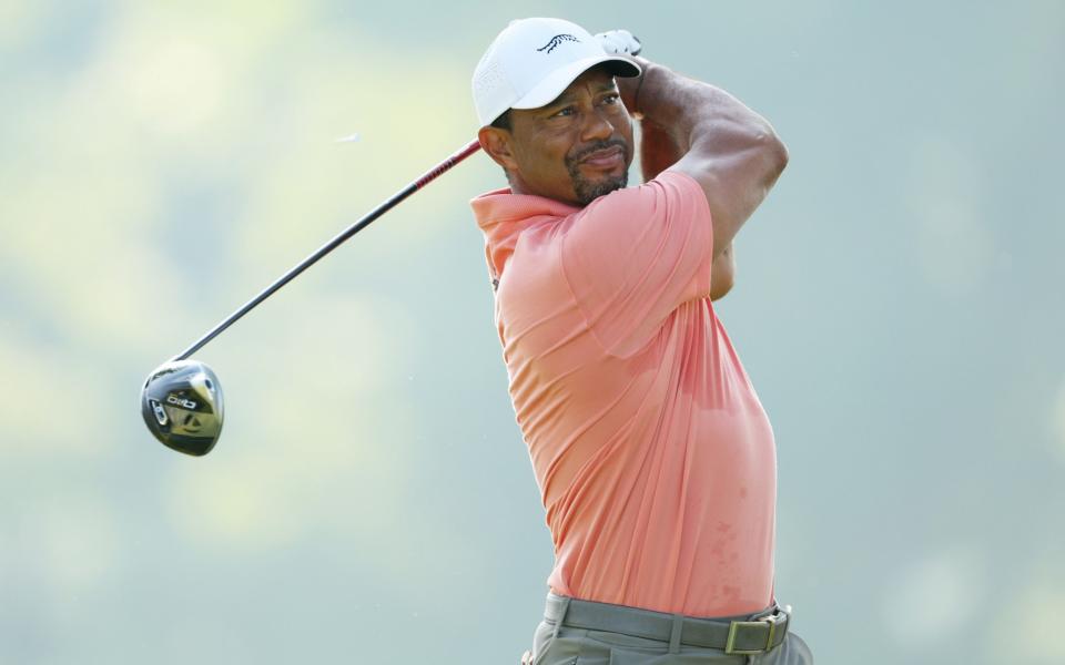 Tiger Woods of the United States hits his shot from the 12th tee during the first round