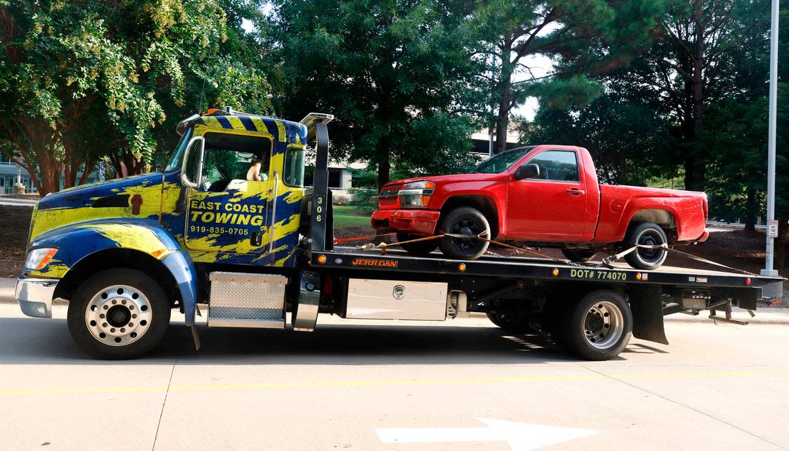 A red pickup truck is transported to the Wake County Detention Center/City-County Bureau of Identification in Raleigh, N.C., Wednesday, August 17, 2022. The truck was seized by law enforcement officials on Wednesday in Winston-Salem in the investigation of the killing of Wake County Deputy Ned Byrd. Ethan Hyman/ehyman@newsobserver.com