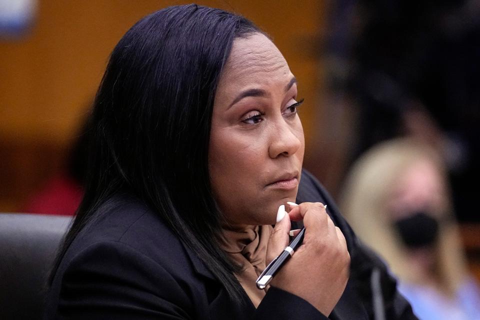 Fulton County District Attorney Fani Willis watches proceedings during a Jan. 24 hearing in Atlanta to decide if the final report by a special grand jury looking into possible interference in the 2020 presidential election can be released.