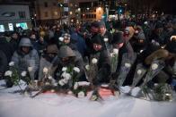 <p>People lay flowers in memory of the victims near the Islamic Cultural Center in Quebec City, Canada on Jan. 29, 2018. On Jan. 29, 2017, just after the Sunday evening prayer, a gunman burst into the mosque in a residential neighborhood of Quebec City and opened fire on worshippers, killing six worshippers. Photo from Alice Chiche/AFP/Getty Images. </p>