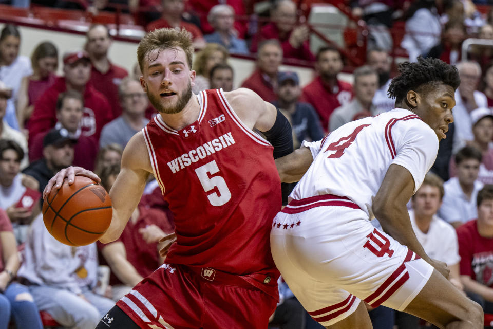 Wisconsin forward Tyler Wahl (5) makes a move around Indiana forward Anthony Walker (4) along the baseline during the first half of an NCAA college basketball game Tuesday, Feb. 27, 2024, in Bloomington, Ind. (AP Photo/Doug McSchooler)