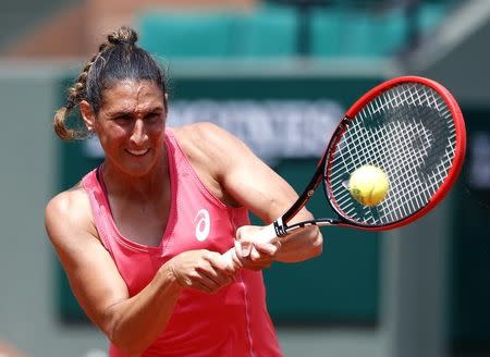 Virginie Razzano of France plays a shot to Veronica Cepede Royg of Paraguay during their women's singles match at the French Open tennis tournament at the Roland Garros stadium in Paris, France, May 25, 2015. REUTERS/Pascal Rossignol