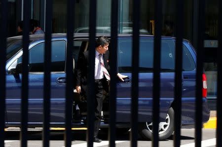 North Korean officials arrive in an embassy car at the VIP entrace at Beijing airport ahead of an Air China flight to Pyongyang, China, March 31, 2017. REUTERS/Thomas Peter