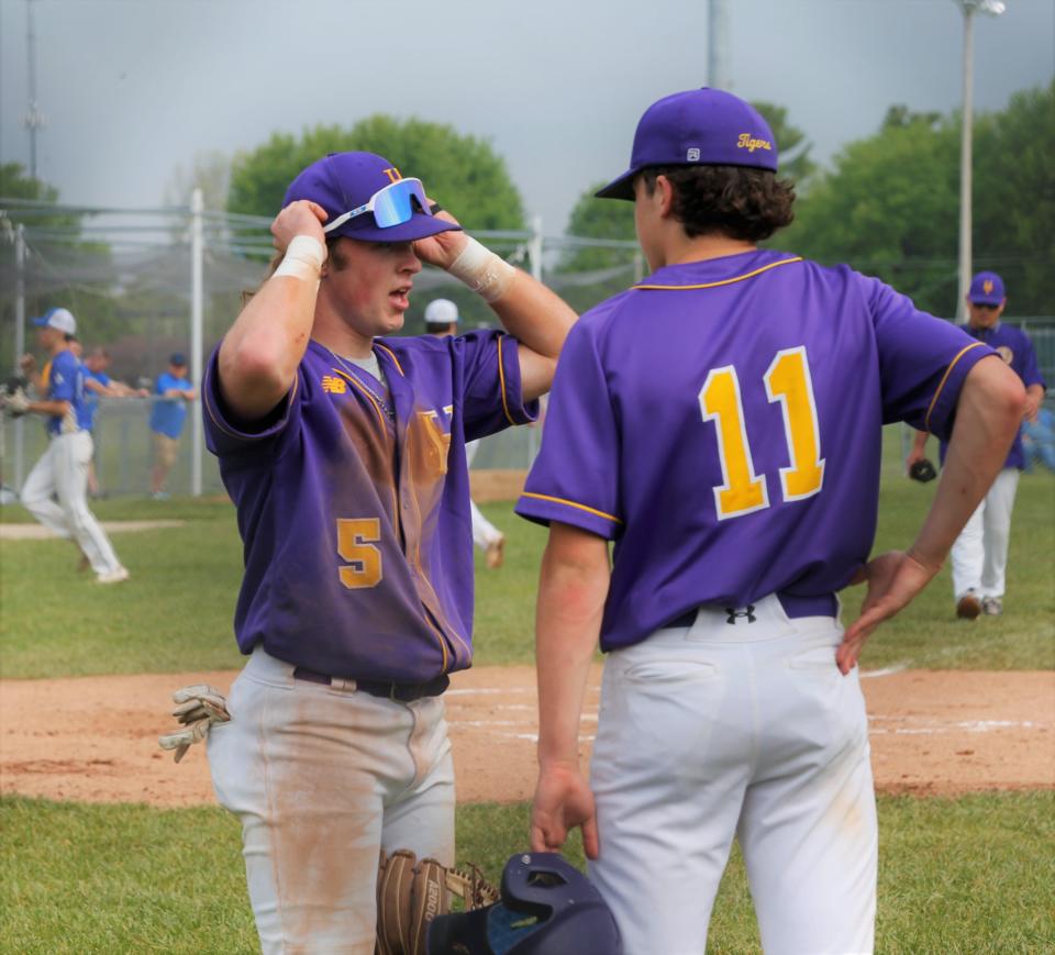 Hagerstown junior Collin Beaty (left) talks with sophomore Will King (right) before taking the field during a Wayne County Tournament game against Lincoln May 13, 2023.