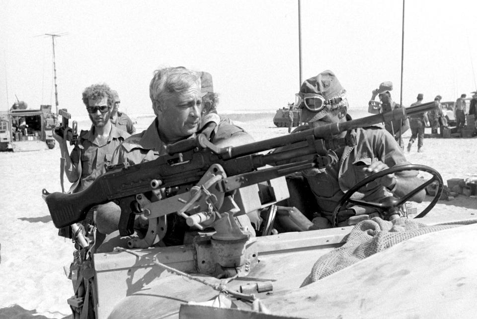 Israeli Major General in the Reserves Ariel Sharon (front L) rides in a jeep in this October 1973 file photo released by Israel's Defence Ministry. Ariel Sharon passed away on January 11, 2014 at the age of 85. REUTERS/Israel's Defence Ministry/Handout/Files (OBITUARY MILITARY POLITICS) ATTENTION EDITORS - FOR EDITORIAL USE ONLY. NOT FOR SALE FOR MARKETING OR ADVERTISING CAMPAIGNS. THIS IMAGE HAS BEEN SUPPLIED BY A THIRD PARTY. IT IS DISTRIBUTED, EXACTLY AS RECEIVED BY REUTERS, AS A SERVICE TO CLIENTS